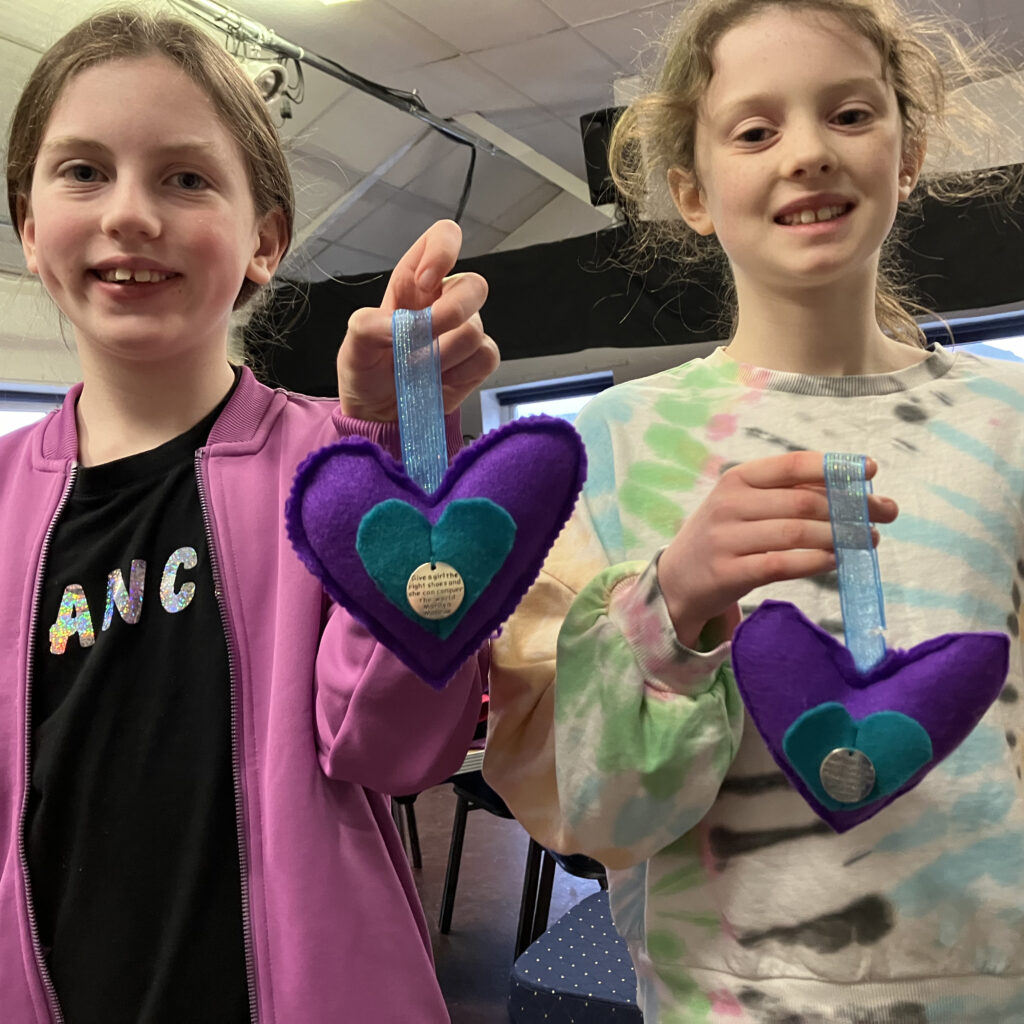 kids showing what they have made at a craft class